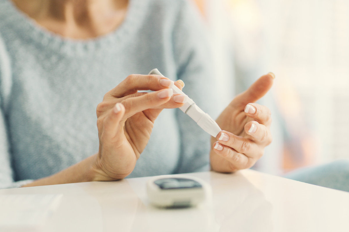 woman testing her glucose (diabetes)